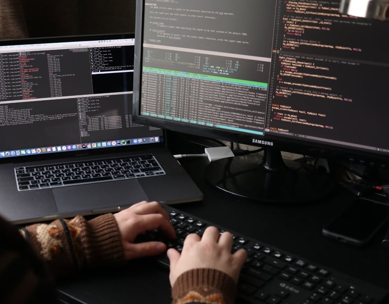 Close up picture of hans workig on computers