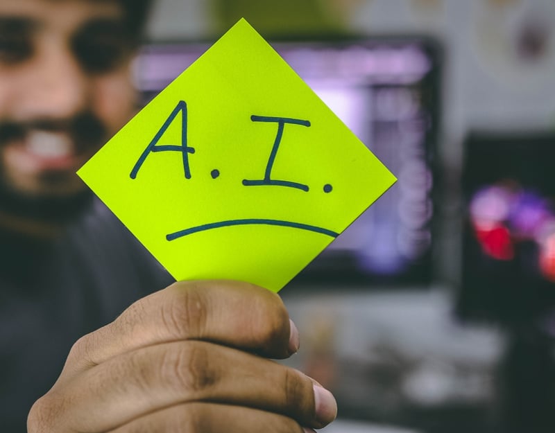 Picture of a post-it note with AI written on it