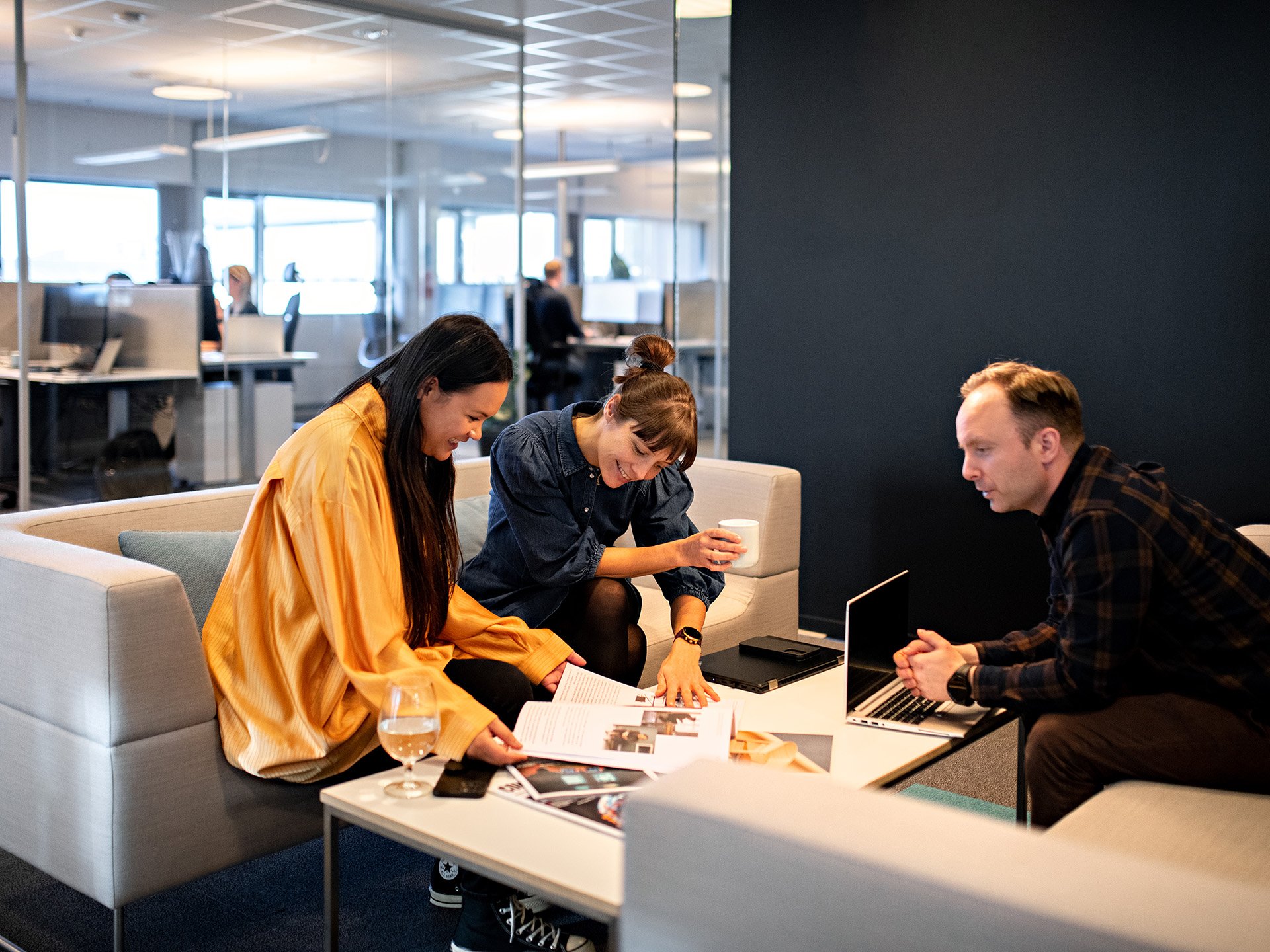 Three people working on a marketing plan