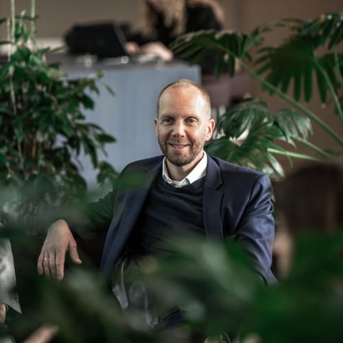 Profile of a man with green plants