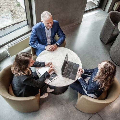 Three people talking having a meeting