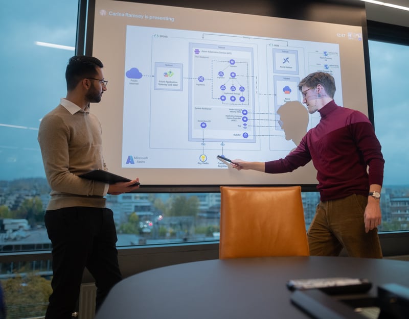 Two men in front of a presentation screen