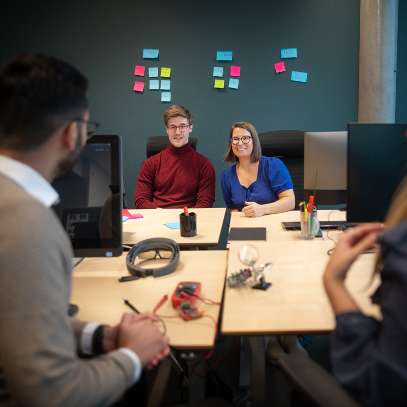 A female and a male colleague receive an overview of a PoC.